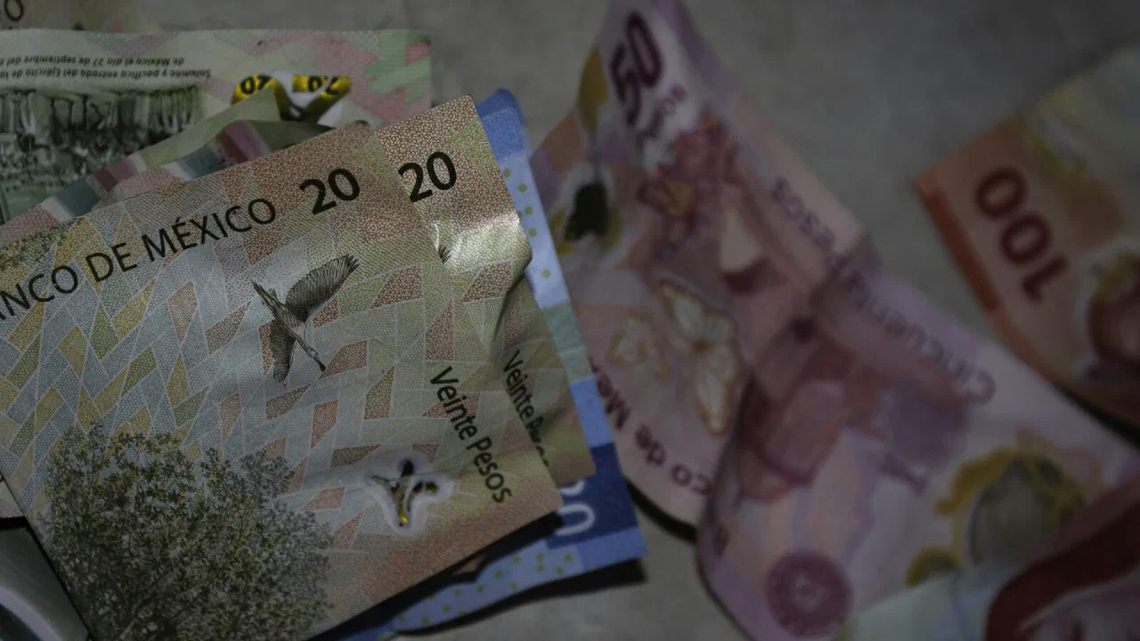 A loose pile of banknotes spread on a table